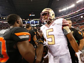Florida State Seminoles quarterback Jameis Winston (5) meets with Oklahoma State Cowboys safety Larry Stephens (20) after the game at AT&T Stadium on Aug 30, 2014 in Arlington, TX, USA. (Matthew Emmons/USA TODAY Sports)