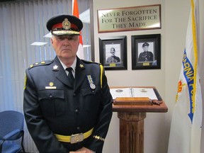 Chief Phil Nelson stands next to a memorial dedicated Wednesday at Sarnia Police headquarters for two officers who died in the line of duty over the history of the city's police service. The dedication service was attended by relatives of Const. John Lewis who died in 1936 and Const. Roy Vanderveer who died in 1944. (PAUL MORDEN, The Observer)