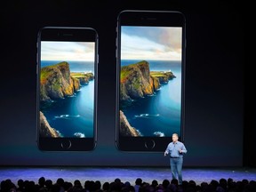 Phil Schiller, senior vice president at Apple Inc., speaks about the iPhone 6 (L) and the iPhone 6 Plus during an Apple event at the Flint Center in Cupertino, Calif., Sept. 9, 2014. REUTERS/Stephen Lam