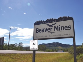 The Beaver Mines sign along Highway 775 is a busy route no matter the season community members say. Some residents are asking MD council for a paved pathway in the community as there is no sidewalk along the highway. They say it is dangerous to let their children travel along the thoroughfare on their own. Other residents have expressed opposition to the idea of the walkway citing privacy concerns. John Stoesser photo/QMI Agency.