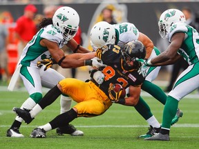 Tiger-Cats’ Andy Fantuz gets taken down by Roughriders on Sunday. The Ticats are looking for their third consecutive win at home.(Reuters)