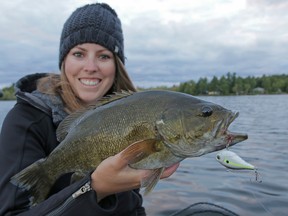 Ashley Rae holds a smallmouth bass she caught last weekend using lipless crankbait. (Supplied photo)