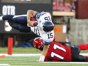 Argos quarterback Ricky Ray gets taken down. Ray is one of just two starters not to get injured so far this season. The other is the RedBlacks' Henri Burris. (Jim Wells/QMI Agency)