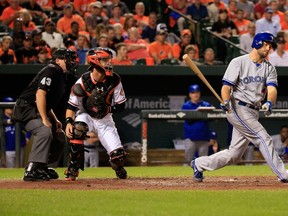 Umpire Paul Schrieber and catcher Caleb Joseph of the Baltimore Orioles look on as Josh Thole of the Toronto Blue Jays reacts after striking out swinging at Oriole Park at Camden Yards on September 17, 2014. (Rob Carr/Getty Images/AFP)