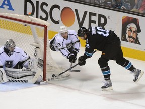 San Jose Sharks center Joe Thornton (19) shoots the puck against Los Angeles Kings goalie Jonathan Quick (32) and center Trevor Lewis (22) during the third period in game seven of the first round of the 2014 Stanley Cup Playoffs at SAP Center at San Jose April 30, 2014. The Kings defeated the Sharks 5-1. (Kyle Terada-USA TODAY Sports)