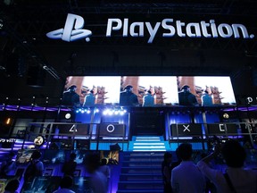 A visitor takes pictures of Sony Computer Entertainment booth at Tokyo Game Show 2014 in Makuhari, east of Tokyo Sept. 18, 2014. REUTERS/Yuya Shino
