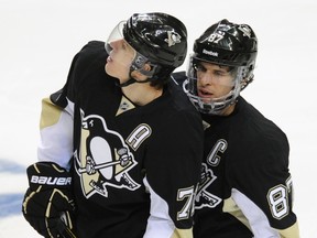 Pittsburgh Penguins' Sidney Crosby (87) and teammate Evgeni Malkin talk during a stoppage of play. (REUTERS/David DeNoma)