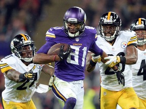 Minnesota Vikings wide receiver Jerome Simpson (81) runs between Pittsburgh Steelers cornerback Cortez Allen (28) and safety Robert Golden (21) during the NFL International Series game at Wembley Stadium. (Bob Martin-USA TODAY Sports)