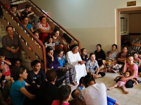 Displaced Iraq Christians who fled from Islamic State militants in Mosul, pray at a school acting as a refugee camp in Erbil September 6, 2014. REUTERS/Ahmed Jadallah