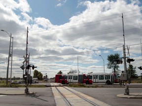 One year ago on Thursday a OC Transpo bus and a Via train crashed along the Woodroffe transitway. A OC Transpo bus crosses the tracks on Woodroffe Ave. in Ottawa Thursday Sept 18,  2014.   Tony Caldwell/Ottawa Sun/QMI Agency