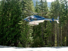 A search and rescue helicopter takes off on a arial search at the site of a plane crash at Narin Falls Provincial Campsite near Pemberton, B.C., on  Saturday, June 29th, 2013. Four people are dead after a plane and a powered glider collided mid-air over a campground. 
DAVID BUZZARD/QMI AGENCY