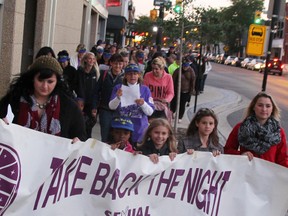 A group of about 100 people marched through the streets of downtown Sarnia Thursday for the community's 21st annual Take Back the Night demonstration. Holding the banner are Kayla Collier, left, Tayleena Sullivan, Gabrielle Smith, Adelaide Smith, Jenna Regier, and Gary Parsons (not pictured). TYLER KULA/ THE OBSERVER/ QMI AGENCY