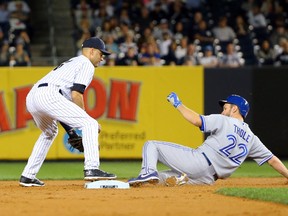 New York Yankees shortstop Derek Jeter has Toronto Blue Jays catcher Josh Thole out at second during the third inning at Yankee Stadium on September 18, 2014. (Anthony Gruppuso/USA TODAY Sports)