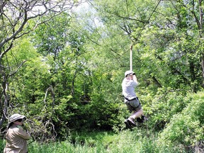 John Mifkovic, leader of the 74th Scout Pack, London, Ont., rides on a zip line at Camp Timken in this 2010 photo.
File photo