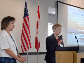 Patty Troy and Kris Lee, U.S. and Canadian chairwomen of the St. Clair Reiver Binational Public Advisory Council, speak at the start of a symposium Thursday to discuss rehabilitation efforts on the St. Clair River.
BETH LEBLANC/TIMES HERALD