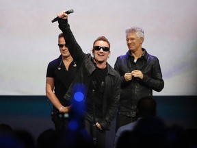 Bono (C) of Irish rock band U2 gestures to the audience after performing at an Apple event at the Flint Center in Cupertino, California, September 9, 2014. REUTERS/Stephen Lam