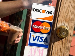 A coffee shop displays signs for Visa, MasterCard and Discover, in Washington in this file photo taken May 1, 2013. (REUTERS/Jonathan Ernst/Files)