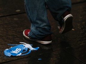 A man walks past a discarded "Yes" campaign paper hat on the Royal Mile after the referendum on Scottish independence in Edinburgh, Scotland on September 19, 2014. Scotland spurned independence in a historic referendum that threatened to rip the United Kingdom apart. (REUTERS/Russell Cheyne)