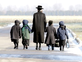Lev Tahor children are walked home during the lunch hour from the makeshift school they attended in Chatham in November. 
QMI Agency file photo