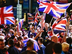 Pro-union protestors chant and wave Union Flags during a demonstration at George Square in Glasgow, Scotland September 19, 2014. (REUTERS/Cathal McNaughton)