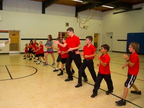 Derek Graystone leads some of the Riverbend Academy students through some basic Akido which is taught as part of the new school's curriculum in Delaware, west of London, Ont. on Thursday September 4, 2014. (MIKE HENSEN, The London Free Press)