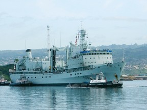 The Royal Canadian Navy ship HMCS Protecteur arrives at Joint Base Pearl Harbor Hickam after it was towed by the U.S. Navy ship USS Sioux after a fire disabled it while at sea in Honolulu, Hawaii, March 6, 2014. (REUTERS/Hugh Gentry)