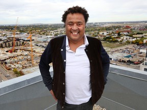 Real Estate king  Bob Dhillon pose on the roof top overlookng the new Arena District In Edmonton on Friday, Sept. 19, 2014. Dhillon acquired 89 properties and the arena is increasing their values. Perry Mah, Edmonton Sun/QMI Agency