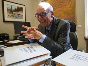 Alberta Health Minister Stephen Mandel sits at his new desk in his office at the Alberta Legislature Building in Edmonton, Alta., on Friday, Sept. 19, 2014. Codie McLachlan/Edmonton Sun/QMI Agency