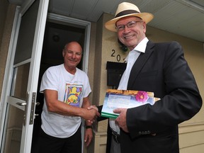 John Fletcher, right, the Wildrose candidate for Calgary-Elbow, door knocks at Vic Urban's house in southwest Calgary on Thursday. Stuart Dryden/Calgary Sun/QMI Agency