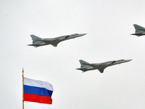 Russian Tupolev Tu-22M supersonic strategic bombers fly above the Kremlin in Moscow.

AFP PHOTO / YURI KADOBNOV