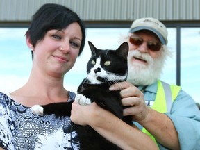 Kelly Graves is joined by her cat Oreo , and trucker Bruce Kaplar (R) at the Bison trucking terminal in Calgary, Alta. after Graves and  Oreo were reunited on Friday September 19, 2014. 
While moving to Alberta from Nova Scotia, Oreo escaped in White River, Ont. 
Locals looked for the cat, and a lady trapped it, then a Bison Transport driver transported the cat to Winnipeg, where another Bison driver, Kaplar, brought the cat to Calgary.
Jim Wells/Calgary Sun/QMI Agency