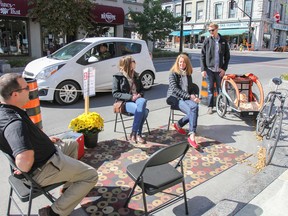 Employees from Fotenn Planning and Urban Design transformed a parking spot on lower Princess Street, below Wellington Street, into a temporary usable public space as part of the Park(ing) Day project on Friday. (JULIA MCKAY/The  Whig-Standard)