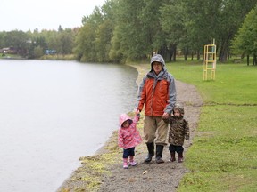 JOHN LAPPA/THE SUDBURY STAR
In this file photo, Jim Mainprize walks with his grandchildren, Kaitlyn, left, and Connor Dermody on the beach at Whitewater Lake Park in Azilda.
