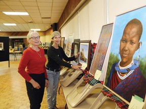 JOHN LAPPA/THE SUDBURY STAR
Sudbury Art Club members Lillian Hrytsak and Christy A. Smith arrange artwork for the annual Northern Ontario Art Association Juried Exhibition at the TM Davies Community Centre in Lively. The public is welcome to attend the exhibition from 2 p.m. to 4 p.m. on Saturday. More than 120 pieces of art from NOAA members in 16 Northern Ontario community art clubs/associations will be shown at the exhibition and sale. A total of 39 pieces of artwork selected from the larger group of art and will be part of a year-long travelling art show across Northern Ontario. The Sudbury Art Club, the Walden Art Club and the Walden Association of Fine Arts are hosting the event.