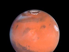 This 1999 Hubble telescope image shows Mars when Mars was 54 million miles (87 million kilometers) from Earth. A NASA spacecraft designed to investigate how Mars lost its water is expected to put itself into orbit around the Red Planet on Sunday after a 10-month journey. REUTERS/NASA/Handout