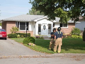 Firefightert on scene of a house fire at 687 Butler Ave. in London on Saturday. DEREK RUTTAN/ The London Free Press /QMI AGENCY