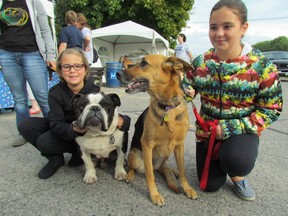 Makayla Simpson, 9, left, holds on to Galileo and her sister Maya Simpson, 11, holds Lili after registering Saturday for the Friends for Life Walk, in support of the Sarnia and District Humane Society. Lili was adopted by the Sarnia family from the animal shelter. PAUL MORDEN /THE OBSERVER/ QMI AGENCY