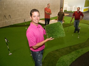 Jason Meyer, owner of Mdrn Utopia, holds a sample of the synthetic grass his company sells in London. With him are employees, from left to right, Tony Sulkowski, Jeremy Meyer and Matt Patterson on a show room putting green. DEREK RUTTAN/ The London Free Press /QMI AGENCY