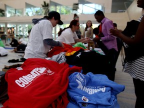 Volunteers hand out t-shirts to youth at the 2014 Combat Crime Youth Think Tank Conference at City Hall  in Edmonton, AB on September 20, 2014. TREVOR ROBB/Edmonton Sun/QMI Agency