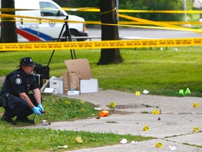 Toronto Police investigate a shooting outside a Lawrence Heights highrise on July 8, 2014. Abshir Hassan, 31, was killed while two others were wounded. (Chris Doucette/Toronto Sun files)