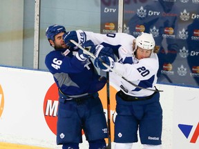 Defenceman Roman Polak (left) and David Booth rough it up during training camp at the MasterCard Centre yesterday. (Veronica Henri/Toronto Sun)
