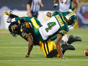 Edmonton Eskimos Adarius Bowman fails to catch a pass while being defended by Hamilton Tiger-Cats Brandon Stewart during the first half of their CFL football in Hamilton, September 20, 2014.    REUTERS/Mark Blinch (CANADA - Tags: SPORT FOOTBALL)
