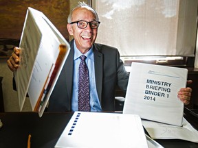 Alberta Health Minister Stephen Mandel sits at his new desk in his office at the Alberta Legislature Building in Edmonton, Alta., on Friday, Sept. 19, 2014. Codie McLachlan/Edmonton Sun/QMI Agency