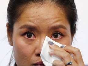 Tennis player Li Na of China cries during a news conference announcing her retirement in Beijing September 21, 2014. (REUTERS/Petar Kujundzic)