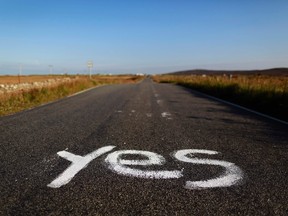 Graffiti supporting the "Yes" campaign is painted on a road in North Uist in the Outer Hebrides September 17, 2014. REUTERS/Cathal McNaughton