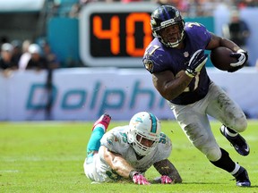Baltimore Ravens running back Ray Rice runs past Miami Dolphins outside linebacker Koa Misi during the second half at Sun Life Stadium on October 6, 2013. (Steve Mitchell/USA TODAY Sports)