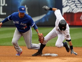 New York Yankees right fielder Ichiro Suzuki beats the tag of Toronto Blue Jays second baseman Ryan Goins for a stolen base in the fourth inning at Yankee Stadium on September 21, 2014. (Noah K. Murray/USA TODAY Sports)