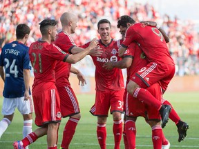 Toronto FC forward Luke Moore (27) celebrates scoring a goal with Toronto FC forward Gilberto (9) during the first half in a game against Chivas USA at BMO Field on Sunday. (Nick Turchiaro-USA TODAY Sports)