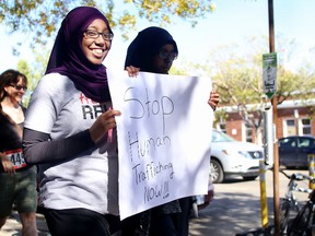 Amal Mohamud, 21, left, and her cousin Muna, 18, march along Whyte Avenue in the 2014 Freedom Relay against human trafficking in Edmonton, AB on September 21, 2014. TREVOR ROBB/Edmonton Sun/QMI Agency