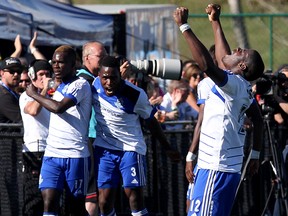 (left to right) FC Edmonton's Lance Laing (17), Eddie Edward (3) and Kareem Moses (12) celebrate Laing's goal against the Tampa Bay Rowdies' during second half NASL action at Clarke Stadium in Edmonton Alta., on Sunday Sept. 21, 2014. David Bloom/Edmonton Sun/QMI Agency